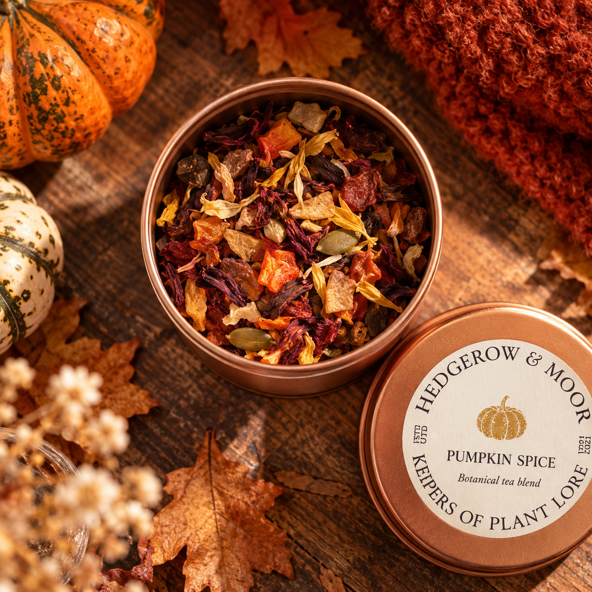 Hedgerow & Moor Pumpkin Spice Botanical Tea in a rose gold tin with autumn leaves and pumpkins