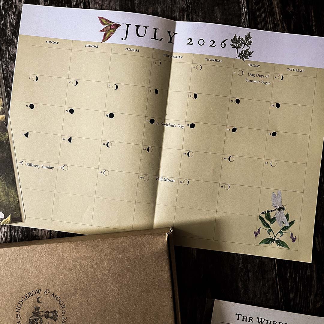 Hedgerow and Moor moon phase Calendar for July 2026 with botanical illustrations on a wooden surface.