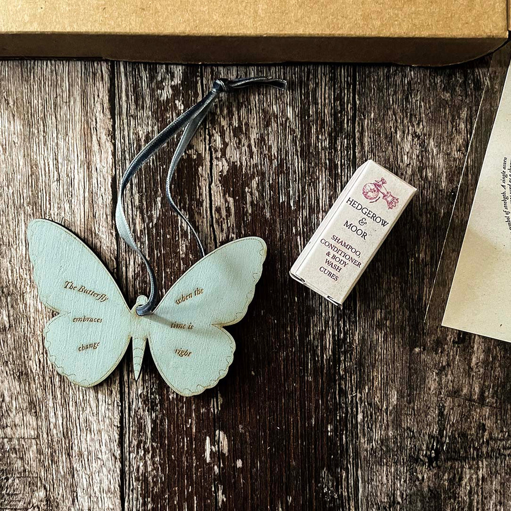 Hedgerow and Moor Butterfly-shaped collectible decorative totem with a box and paper on a wooden surface