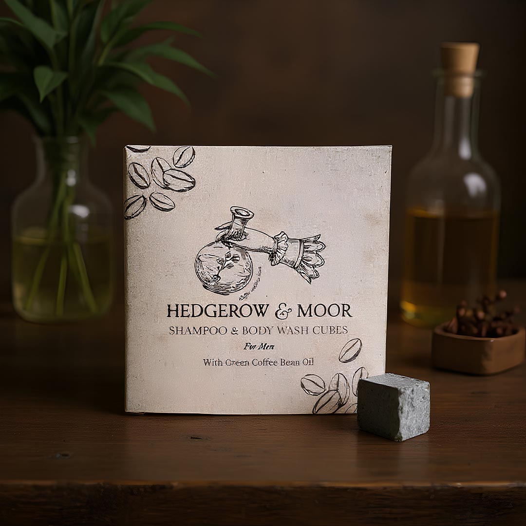 Box of Hedgerow & Moor shampoo and body wash cubes for men on a wooden surface with a bottle and plant in the background.