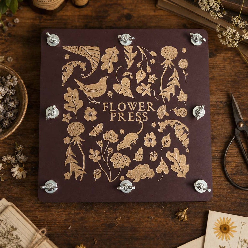 Handmade Flower press with floral designs and 'Flower Press' text on a wooden surface.
