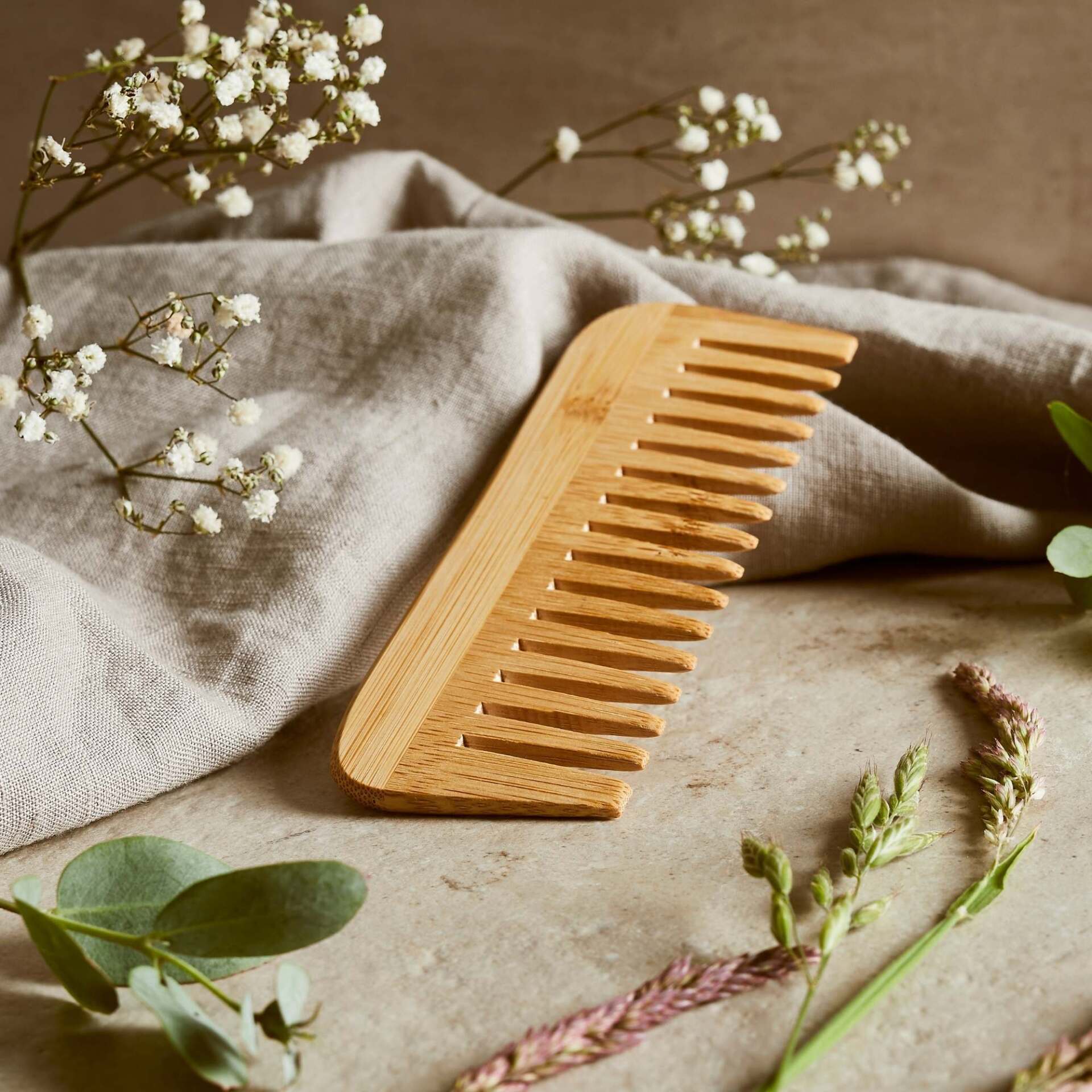 Natural bamboo comb by Hedgerow & Moor — eco-friendly plastic-free hair comb resting on neutral background.