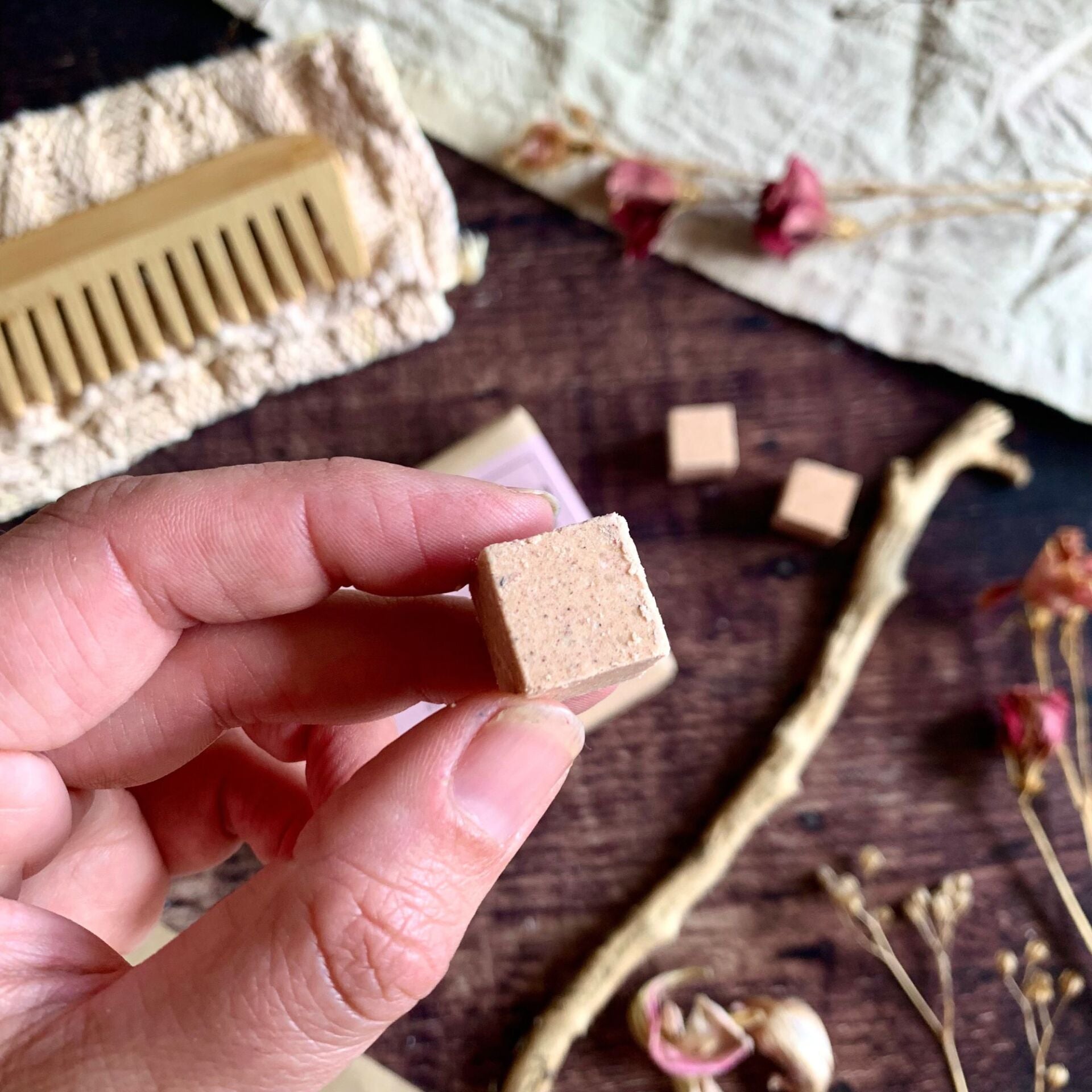 Close-up of creamy conditioner cube beside open paper pack — eco-friendly silicone-free conditioning treatment for soft, nourished hair.