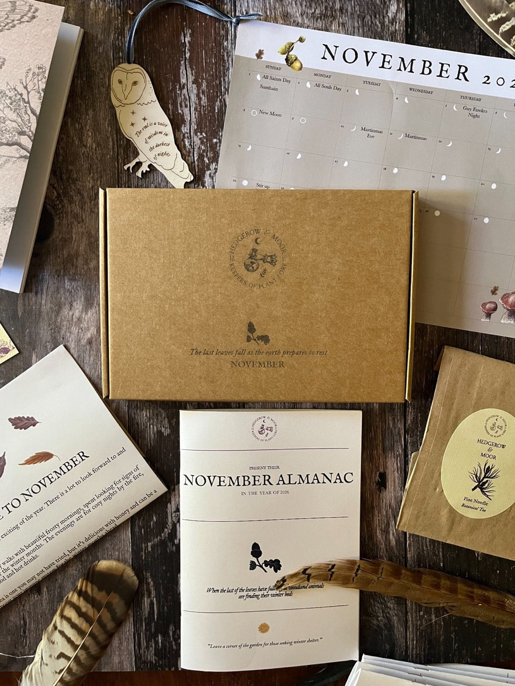 November 2026 box with wooden owl decoration, moon-phase calendar, Almanac zine and Pine Needle Tea.