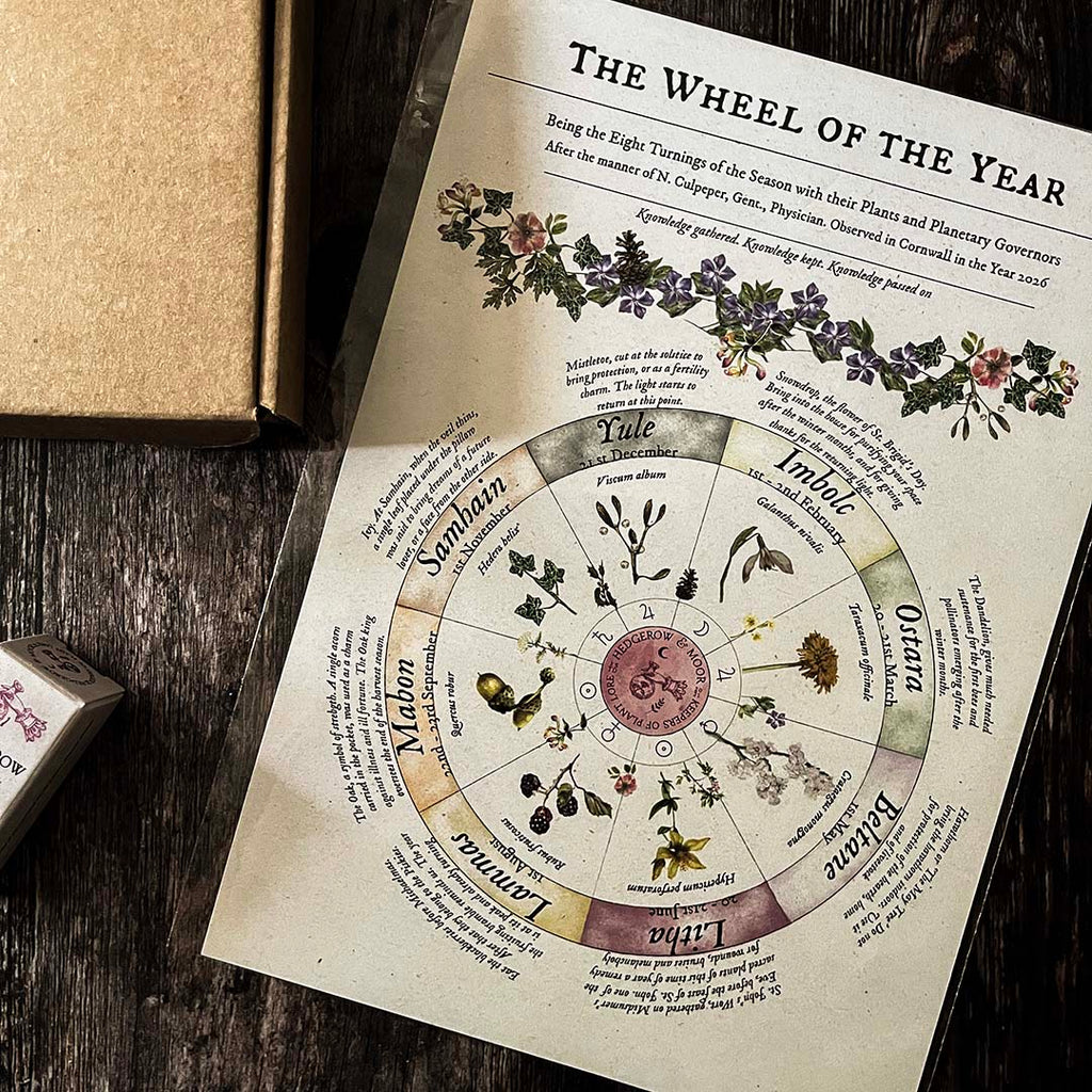 hedgerow and moor Wheel of the Year art print with herbs on a wooden surface