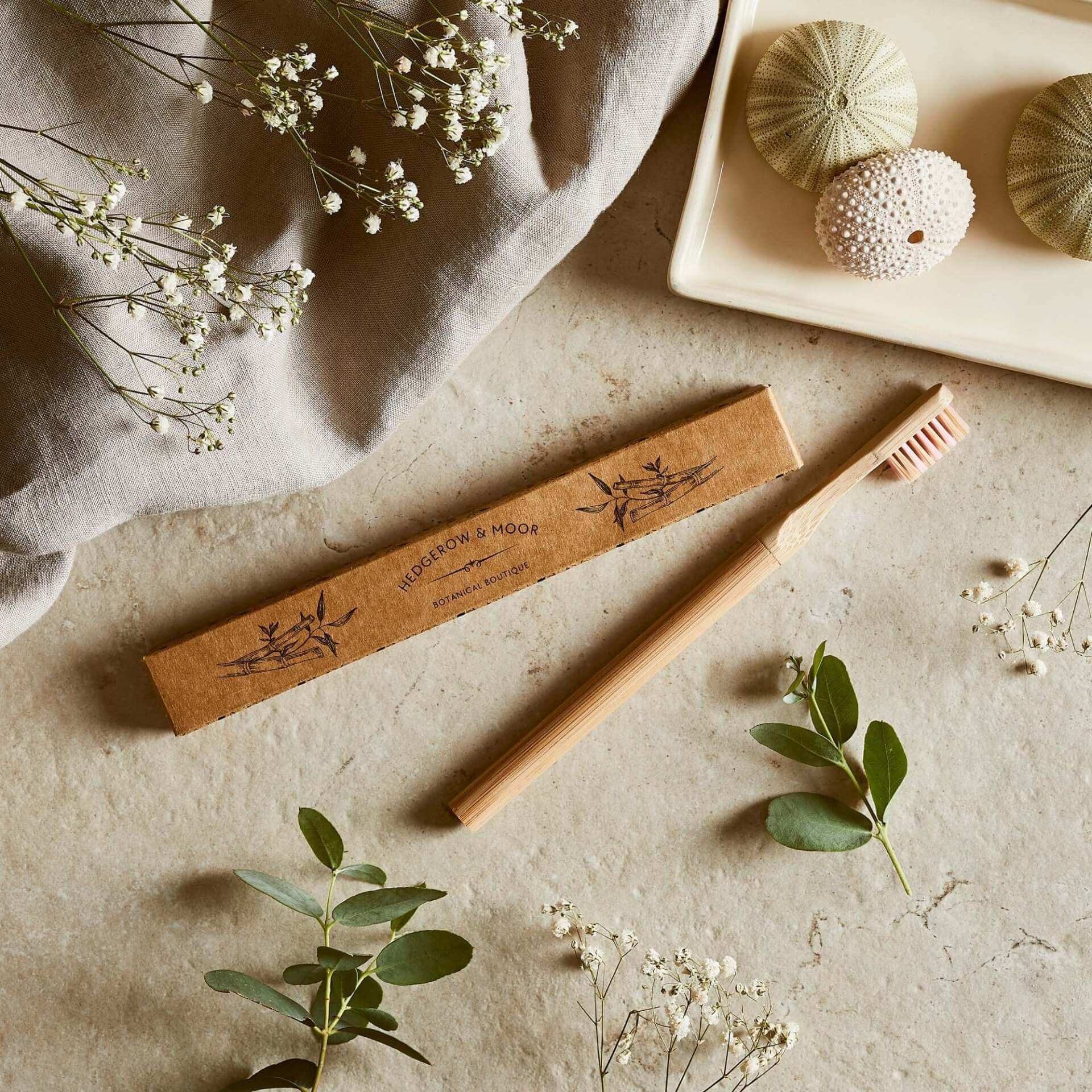 A kraft box with a plastic free, bamboo toothbrush with replaceable head