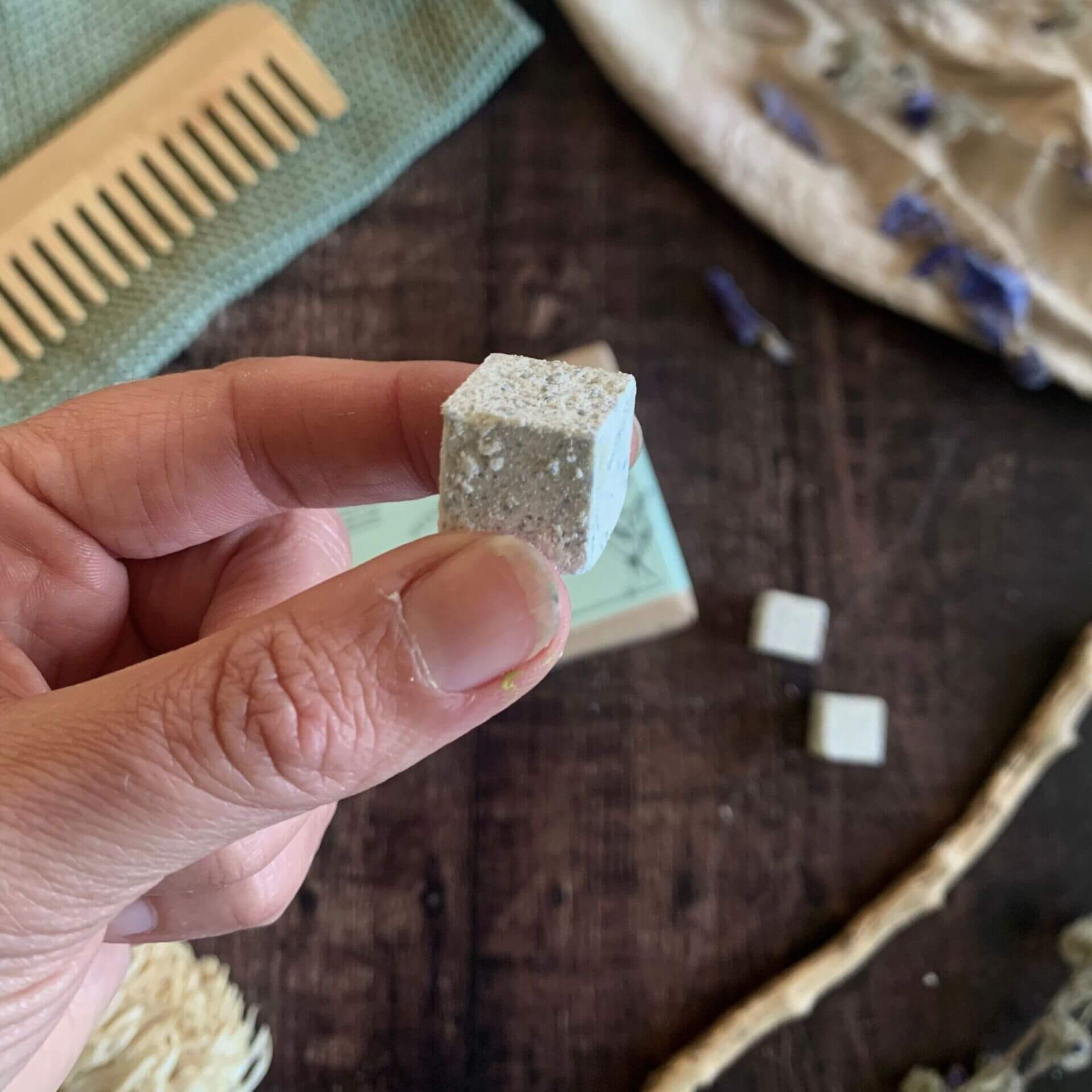 Close-up of soothing conditioner cube beside open compostable pack — eco-friendly, scalp-balancing conditioning treatment for sensitive hair and skin